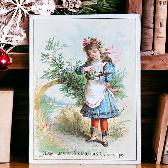鳥の巣を持つ少女を描いたアンティークのビクトリア朝クリスマスカード 