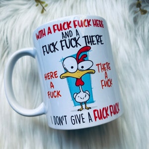 May include: White ceramic mug with a humorous cartoon chicken design. The mug features the text "WITH A FUCK FUCK HERE AND A FUCK FUCK THERE" and "I DON'T GIVE A FUCK FUCK". The design includes a cartoon chicken with a red comb and a small chick.