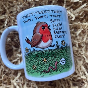 May include: White ceramic mug featuring a cartoon robin and the text "TWEET! TWAT! SHIT! FUCK! DICK! BASTARD! CUNT!". The robin is in grass with a worm saying "Excuse me!".