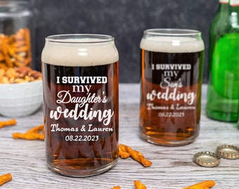 May include: Two clear glass beer mugs with the text "I survived my daughter's wedding" and "I survived my son's wedding" with the date of the wedding. The mugs are filled with a dark brown liquid and are sitting on a wooden surface with pretzels.