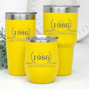 May include: Three yellow stainless steel tumblers with a black inscription that reads "EST. 1986 Limited Reserve Aged to Perfection".