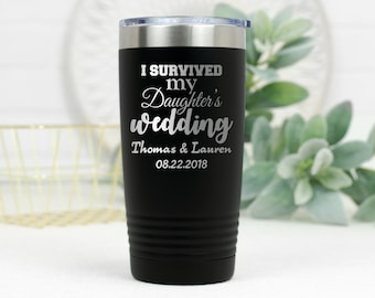 May include: Black stainless steel tumbler with the text "I survived my daughter's wedding" and the names "Thomas & Lauren" and the date "08.22.2018" engraved on the side.