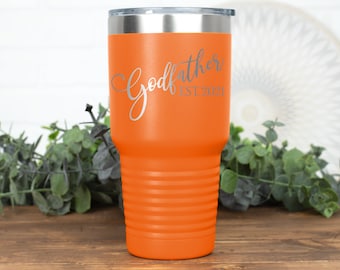 May include: Orange stainless steel tumbler with a silver lid and the text "Godfather Est. 2021" engraved on the front.