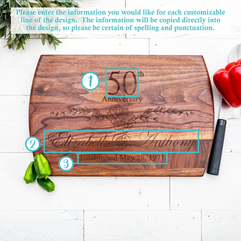 May include: A wooden cutting board with a personalized inscription. The inscription reads "50th Anniversary", "Elizabeth & Anthony", and "Established May 28, 1971".