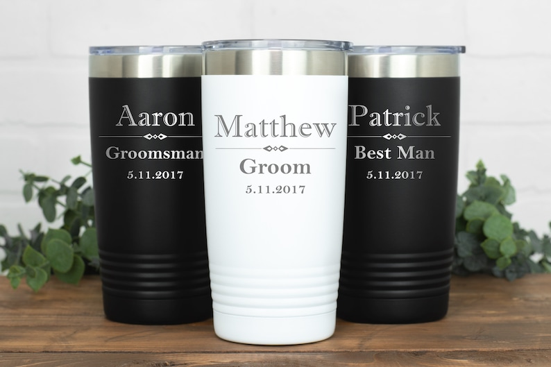 May include: Three black and white stainless steel tumblers with personalised names and titles, "Aaron,  Groomsman, 5.11.2017", "Matthew, Groom, 5.11.2017", and "Patrick, Best Man, 5.11.2017".
