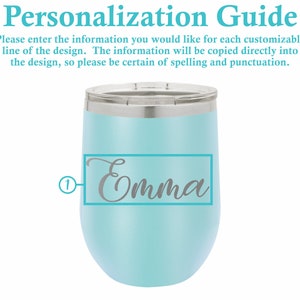 Puede incluir: Un vaso de vino de acero inoxidable azul claro con una tapa plateada. El vaso tiene una inscripci&oacute;n personalizada que dice "Emma" en una fuente cursiva gris.