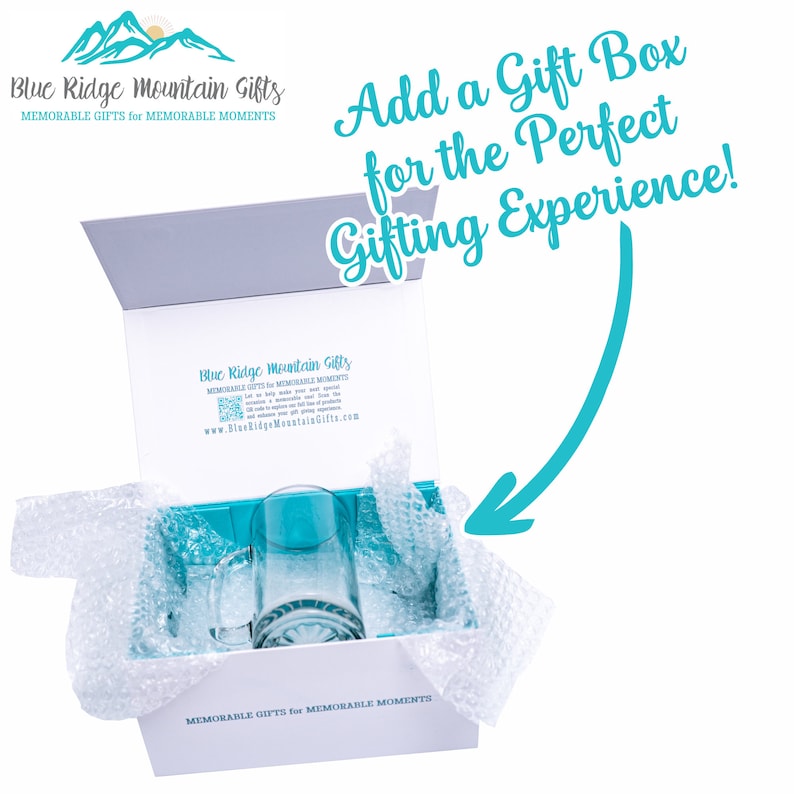 May include: A white gift box with a blue and white logo that says "Blue Ridge Mountain Gifts" and "MEMORABLE GIFTS for MEMORABLE MOMENTS". The box is open and a clear glass mug is inside. The box is surrounded by bubble wrap.