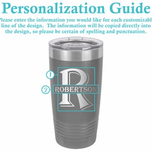 May include: A gray insulated tumbler with a silver lid. The tumbler features a personalized design with the letter "R" and the name "ROBERTSON" in a rectangular box. The text "Personalization Guide" is at the top.