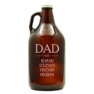 May include: A brown glass growler with a white inscription that reads "DAD EST 10.18.90 03.25.93 01.03.99 06.10.04".