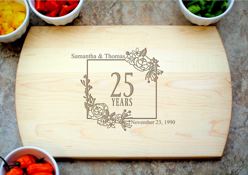 a rectangular cutting board made from high-quality wood that engraved name, date, and "25th-anniversary" symbol is the best gift for 25th anniversary