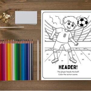 May include: A coloring book page with a soccer theme, featuring a player heading a soccer ball. The text "HEADER!" is at the bottom, along with instructions to color the scene. A set of colored pencils and a white pencil are next to the coloring book.