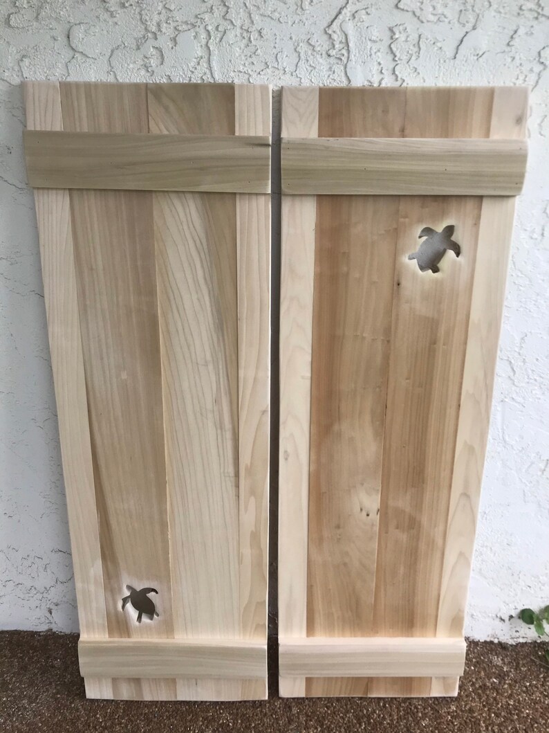 Solid wood exterior window shutters with baby sea turtle