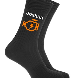 May include: Black socks with a white name "Joshua" and an orange engine light icon.