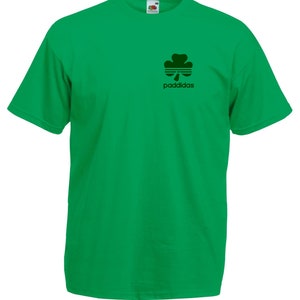 May include: A green t-shirt with a black shamrock and the text "paddidas" printed on the front.