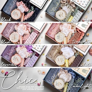 May include: Gift boxes in various colors, including black, sage, blush, terracotta, lavender, white, and moonlight. Each box contains a compact mirror, scrunchies, a comb, and other accessories. The word "Chic" is written in cursive at the bottom.