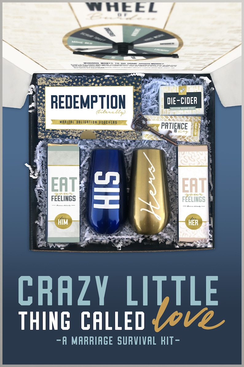 May include: A gift box set for couples with the text "Crazy Little Thing Called Love - A Marriage Survival Kit" on the front. The box contains two champagne flutes, one blue and one gold, with the words "His" and "Hers" on them. The box also contains two small boxes with the text "Eat Your Feelings" and a key with a tag that says "Patience is Key".