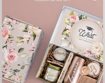May include: A graduation spa gift set in a floral box containing a bath bomb labeled Soak, a candle labeled Glow, a tube of bath salt, a rose gold tumbler personalized with the name Brianna, and a bar of soap labeled Wash with a letter B lid.