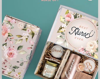 May include: A gift box set featuring a rose gold tumbler with the name Brianna, a candle labeled Glow, a bath bomb labeled Soak, a tube of bath salt, and a bar of soap labeled Wash. The box lid features floral patterns and the text Best Nurse Ever.