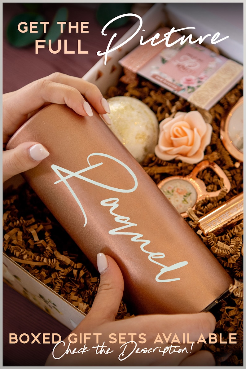 May include: A rose gold tumbler with the name "Raquel" in white script is held in a gift box filled with decorative paper. The box contains a bath bomb, a rose-shaped soap, and other gifts. Text on the image reads "Get the Full Picture" and "Boxed Gift Sets Available".