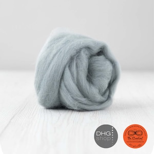 May include: A close-up of a light blue wool roving, a type of fibre used for felting and spinning.