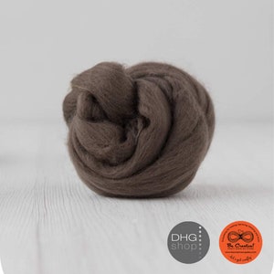 May include: A ball of brown wool roving, a type of fibre used for felting and spinning.