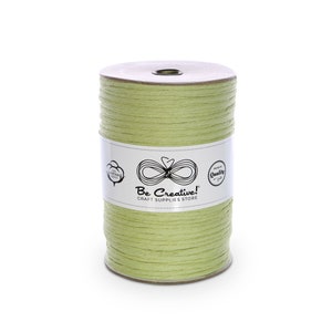 May include: A spool of light green cotton cord, wrapped around a brown cardboard tube. The label on the spool reads "Be Creative! Craft Supplies Store".