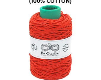 May include: A spool of vibrant red cotton string, labeled "COTTON SINGLE STRING (100% COTTON)". The label reads "Be Creative! CRAFT SUPPLIES STORE". The spool is 3 mm thick and contains approximately 656 feet of string.