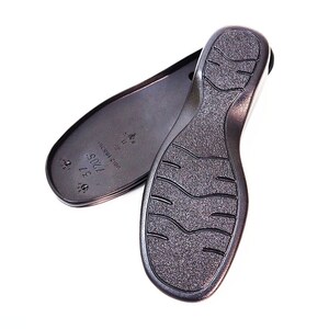May include: A pair of black shoe soles with a textured tread pattern. The sole on the left has the text "7005 37 1/2" and "MADE IN CHINA" printed on it.