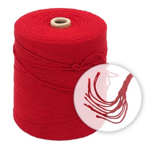 May include: A spool of red cotton twine. The twine is wound tightly around the spool and is ready to be used for crafting, wrapping, or other projects.