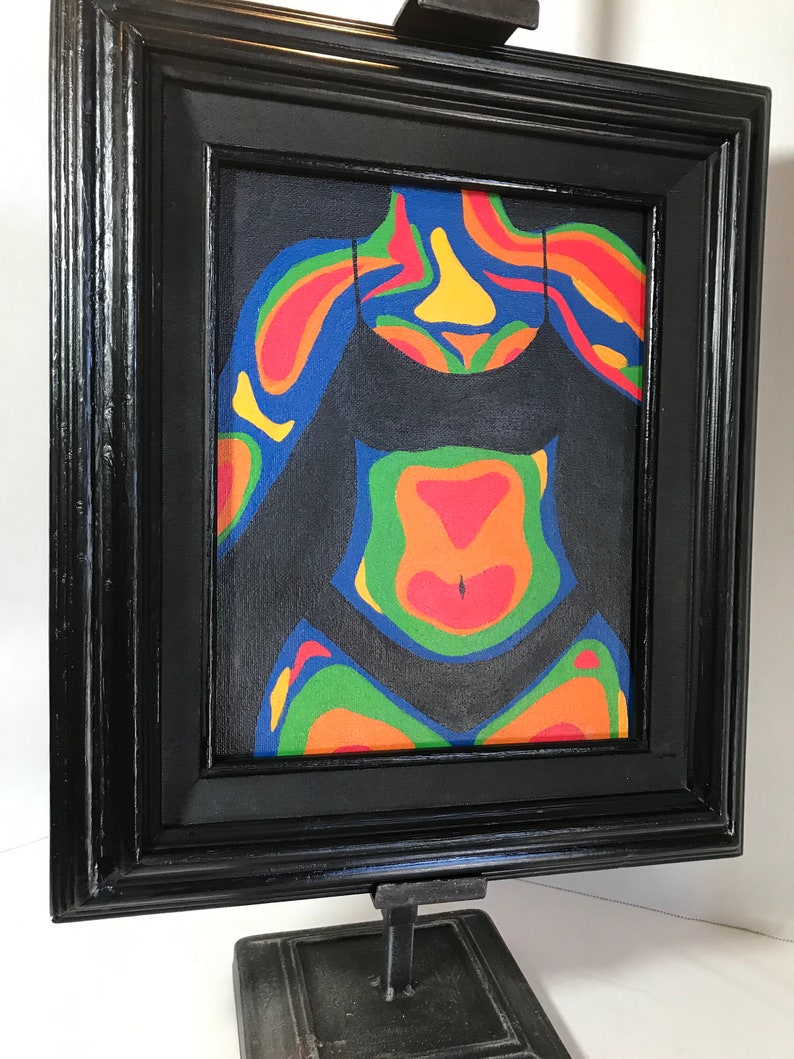 May include: A framed painting of a person's torso with a black swimsuit. The painting is done in a colorful abstract style with a thermal imaging color palette.
