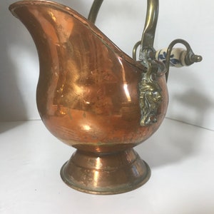 Vintage copper Dutch helmet scuttle bucket, Vtg aged copper coal bucket, Vtg copper pot porcelain handle and brass lion head details.