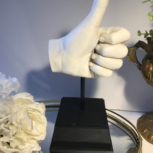 Plaster heavy hand sculpture on black tapered base, White detailed thumbs up hand statue on black museum display style base, hand sculpture