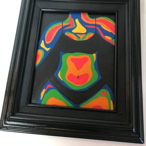 May include: A framed painting of a person's torso with a black background and colorful, abstract, swirling patterns in shades of red, orange, yellow, green, and blue.