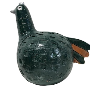 May include: A dark green ceramic bird ornament with a textured finish. The bird features a long neck, a small beak, and a small silver crown. The wings are brown and green.