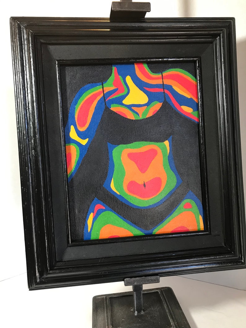 May include: A framed painting of a person's torso in a black swimsuit. The painting is done in a thermal imaging style with colors ranging from blue to red.