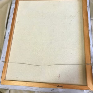 May include: The back of a framed canvas painting with a wooden frame. The canvas is white and has a wire attached to the back for hanging. The frame has a label that reads "C 0000 35".