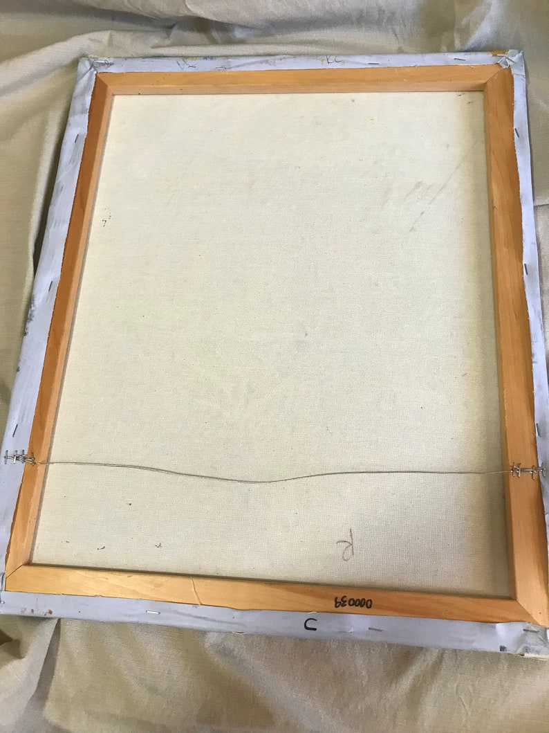 May include: The back of a framed canvas painting with a wooden frame. The canvas is white and has a wire attached to the back for hanging. The frame has a label that reads "C 0000 35".