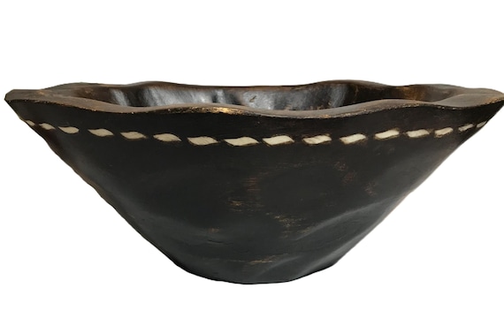 A large vintage-style carved wood bowl with decorative inlay work — the kind of statement piece that anchors a console table and prompts 'where did you get that?'