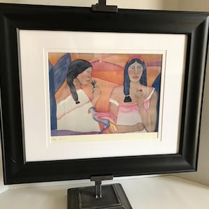 May include: Framed print of a painting depicting two women with long dark hair, one wearing a white dress and the other a pink dress, against a colorful background.