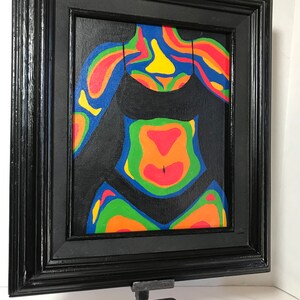 May include: A framed painting of a person's torso with colorful abstract patterns on a black background.