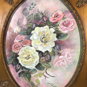 May include: A framed painting of a bouquet of white and pink roses with green leaves on a pink background. The painting is signed "Gloria Curtis".
