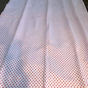May include: White fabric with a pink polka dot pattern. The fabric is folded in thirds.