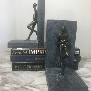 Modern style bookends, contemporary stone look bookends with bronze figurine, unique stone finish modern bookend set