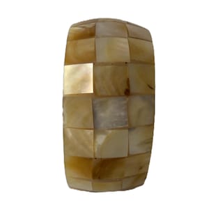 May include: A rectangular decorative object with a curved top, composed of small, square, iridescent, and beige-coloured tiles. The tiles are arranged in a checkerboard pattern, creating a mosaic effect. The object has a smooth, polished surface.