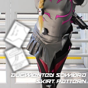 May include: A gray and black skirt with pink accents. The skirt has pleats and a high waist. The text "Augmented Sombra Skirt Pattern" is visible at the bottom of the image.