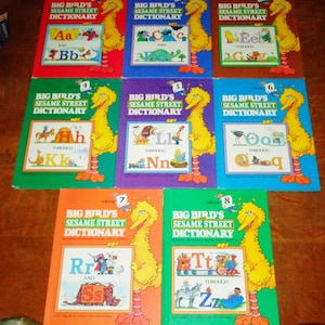 May include: Eight colourful books with Big Bird's Sesame Street Dictionary on the cover. Each book features a different letter of the alphabet and a picture of Big Bird.