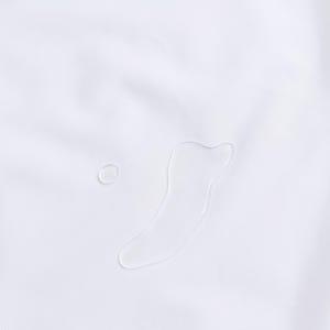 May include: Close-up of a white fabric with two water droplets. One droplet is small and round, while the other is a larger, elongated shape. The fabric has a subtle texture.