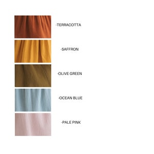 May include: A color palette featuring swatches of fabric in terracotta, saffron, olive green, ocean blue, and pale pink. Each swatch is accompanied by a label indicating the color name. The fabric appears to have a textured, crinkled appearance.