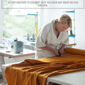 May include: A woman cuts a large piece of mustard yellow fabric with scissors. The fabric is laid out on a table in a workshop setting. The text above reads: "WE GLADLY ACCEPT CUSTOM ORDERS FOR ANY SIZE OR DESIGN AND MORE THAN 40 COLORS. DO NOT HESITATE TO CONTACT US IF YOU HAVE ANY IDEAS WE CAN DISCUSS."