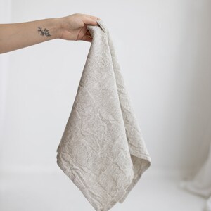 May include: A light gray linen kitchen towel with a textured pattern.